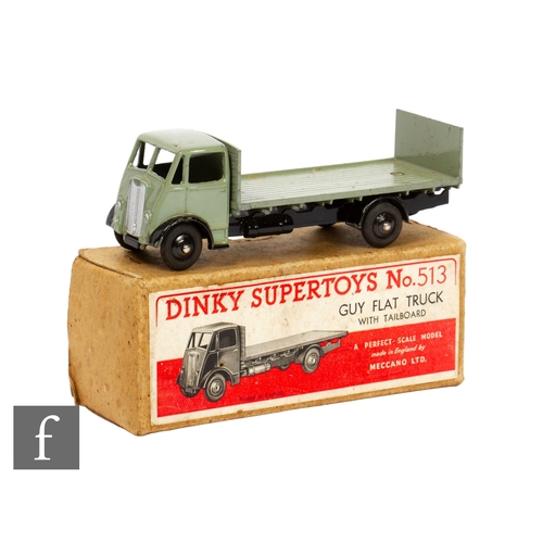 420 - A Dinky Toys 513 Guy Flat Truck with Tailboard, type one, in grey body with black chassis and ridged... 