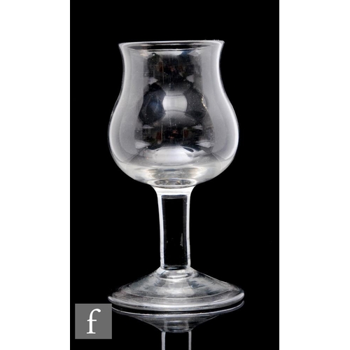 326 - A large 18th Century goblet circa 1740, the tulip bowl with everted rim above a large solid plain st... 