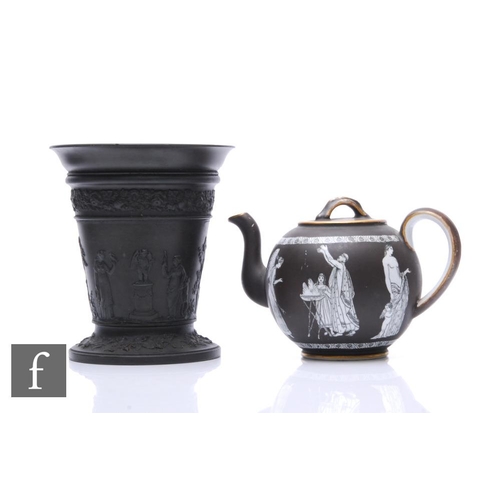 1071 - A Wedgwood black basalt vase, circa 1910, of flared form, sprigged Greco-Roman figural decoration wi... 