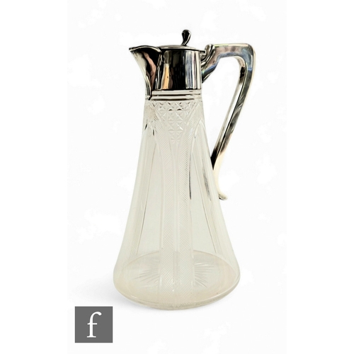 30 - A hallmarked silver and clear cut glass claret jug with part cut tapering glass body terminating in ... 