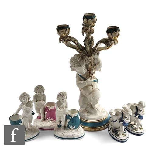 71 - A Copeland figural candelabrum, modelled as a kneeling putti supporting three branched candle sconce... 