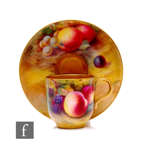 82 - A Royal Worcester fallen fruit painted coffee cup and saucer by Frank Moseley, circa 1930, decorated... 