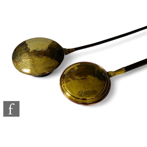 479 - A 17th Century brass warming pan, the domed centre engraved with scroll and leaf design and the oute... 