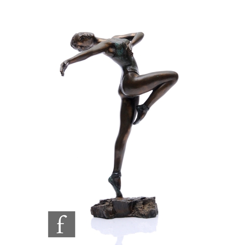 489 - A 20th Century bronze figure of a dancing with knee raised and outstretched arm, on a rocky base, he... 