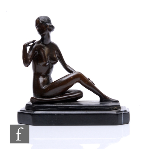 490 - A 20th Century Art Deco style bronze figure of a seated lady looking back over her shoulder, on a st... 