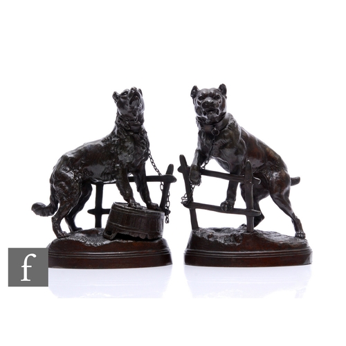 501 - A pair of bronzed spelter studies of two bull dogs, one by a gate and one resting on a tub, after C ... 