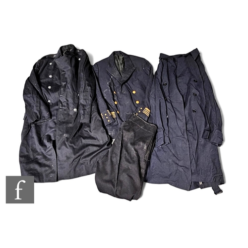 506 - An early 20th Century fireman's blue cloth jacket and trousers together with an over coat, a rain co... 