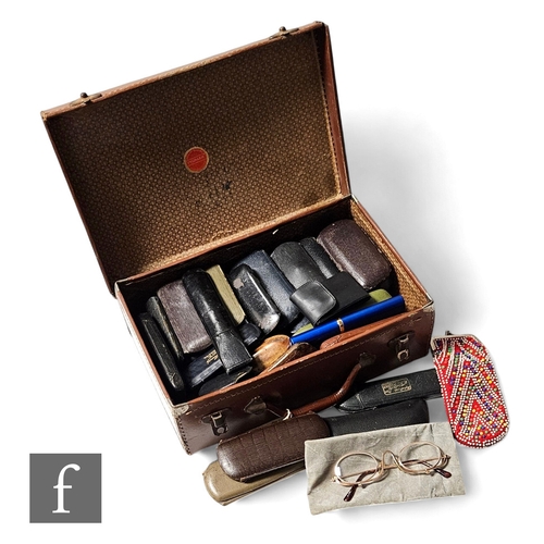 511 - A collection of 19th and 20th Century spectacles in leather cases and a small leather suitcase. (qty... 