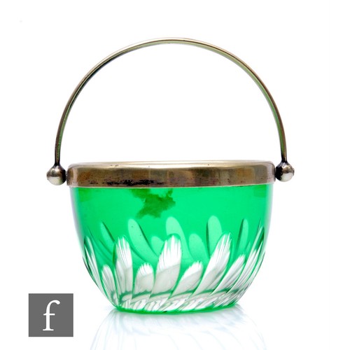 129 - A late 19th Century Stourbridge glass sugar bowl with flash cut panels against a green ground, the h... 