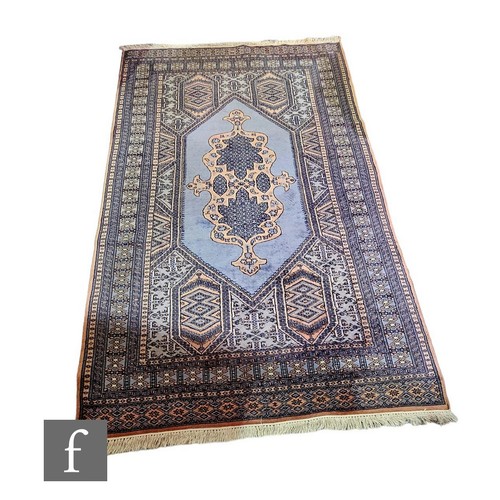 634 - A Central Asian rug, central medallion on a pale blue ground, 262cm x 158cm.PLEASE VIEW CONDITION RE... 