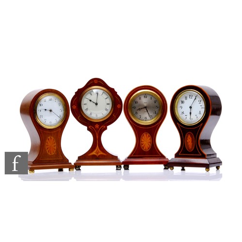 620 - An Edwardian inlaid mahogany balloon shaped mantel clock, the white dial bordered with trailing leav... 