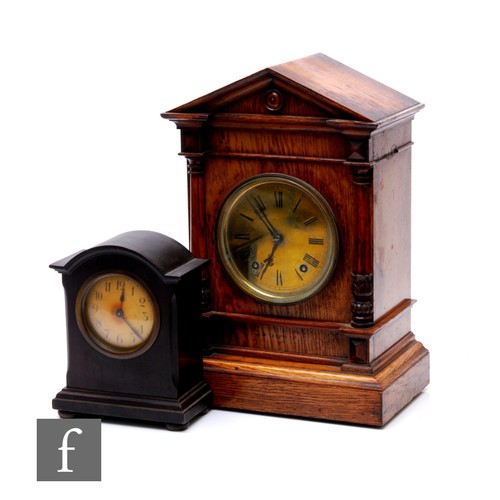 622 - An early 20th Century oak mantle clock of architectural form circular brass dial, eight day striking... 