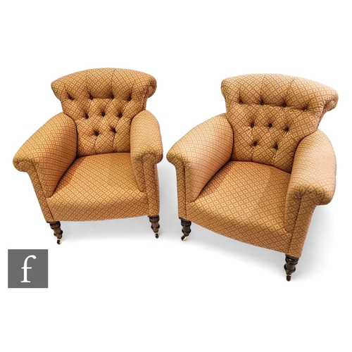 648 - A pair of Victorian button back easy chairs upholstered in pink cross design, on turned legs to the ... 