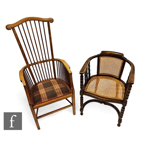 649 - A 20th Century high comb back beech elbow chair, the shaped back rail over a tartan covered seat on ... 