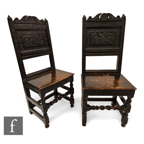 652 - A pair of 18th Century style carved oak back stools, the panels decorated with a leaf design below a... 