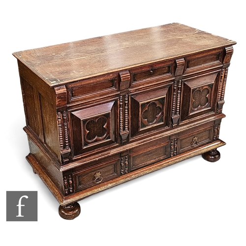 661 - An 18th Century and later constructed oak mule chest, the hinged moulded edge top over a projecting ... 