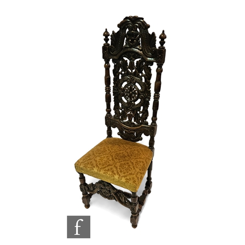 664 - A Charles I style high back standard chair, the pierced scroll back flanked by turned uprights below... 