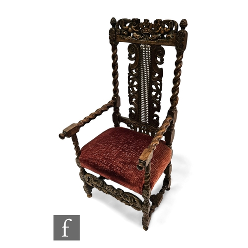 666 - A Charles I walnut period elbow chair, the cane panel back flanked by C scroll mounts to each side a... 