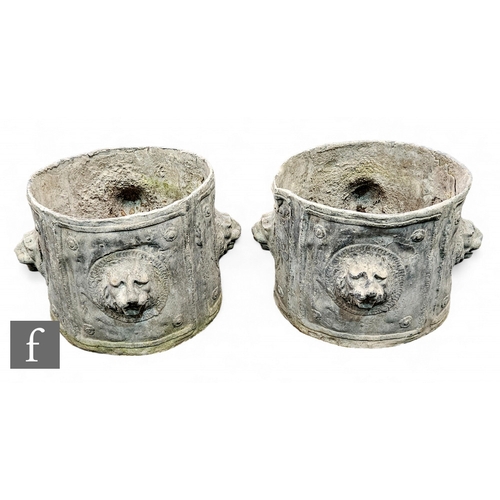 671 - A pair of Regency cylindrical lead planters each mounted with a projecting lion mask head, height 28... 