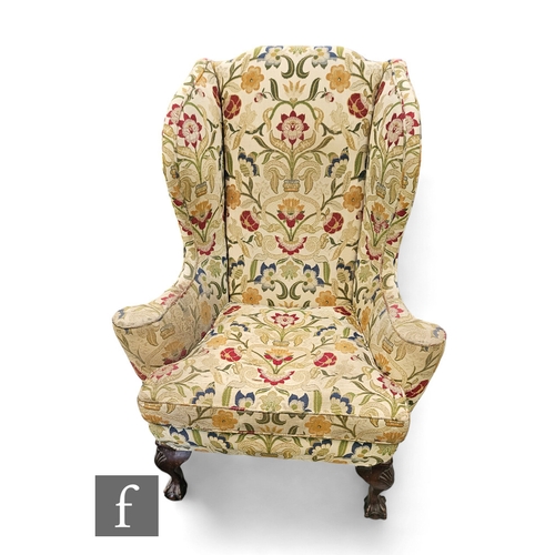 673 - A George III style wing back and scroll arm easy chair on cabriole legs claw and ball feet, upholste... 