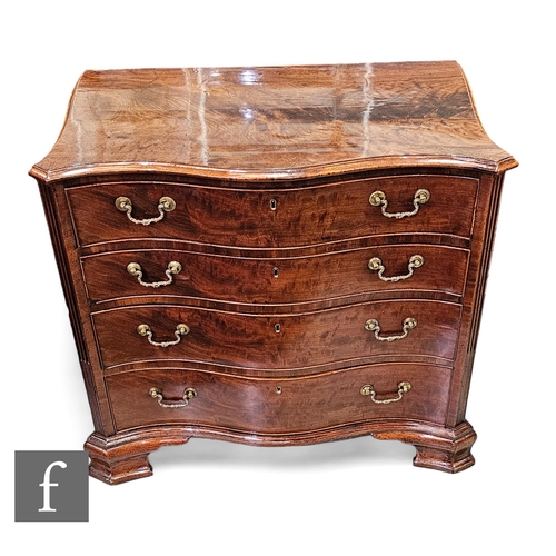 679 - A George III mahogany serpentine chest of four long graduated drawers, the upper drawer with a fitte... 