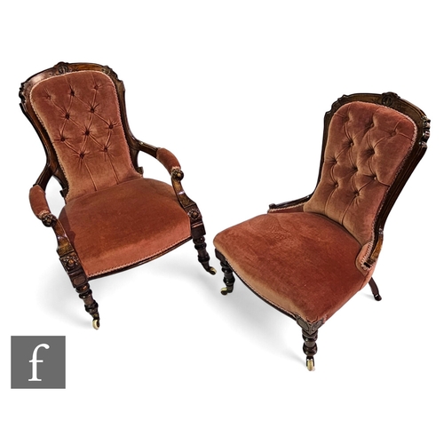 689 - A Victorian carved easy elbow chair on turned legs to the front and castors, with a matching chair, ... 