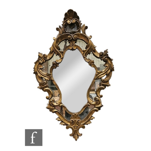 692 - A small 19th Century rococco gilt wall mirror of cartouche form, 75cm x 49cm.PLEASE VIEW CONDITION R... 