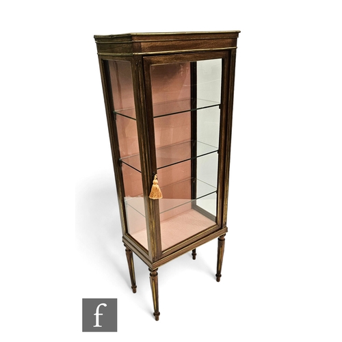 696 - A late 19th Century French Empire style brass mounted floor standing display cabinet, adjustable gla... 