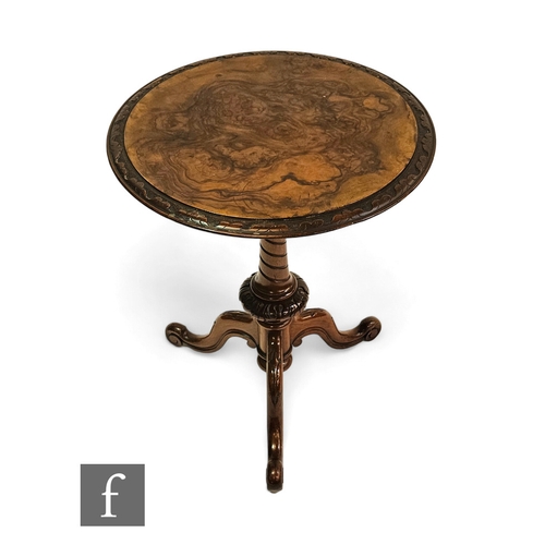 709 - A Victorian figured walnut circular occasional table, the carved top over spiral pedestal and tripod... 