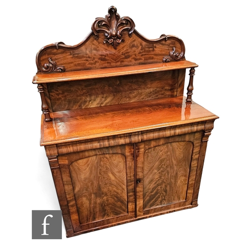 715 - A Victorian mahogany chiffonier enclosed by a pair of doors below a moulded edge and pillar scroll c... 