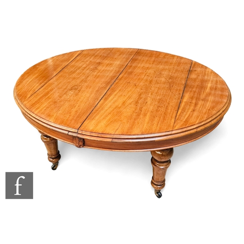 717 - A Victorian oval extending mahogany dining table, the double moulded edge top over a plain frieze, o... 