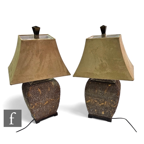 722 - A large pair of 20th Century decorative table lamps and plush covered shades in an African style wit... 