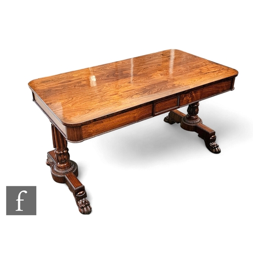 723 - A 19th Century rosewood library table in the style of Gillows of Lancaster, the rounded edge rectang... 