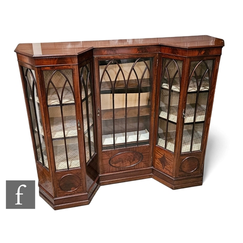 727 - An Edwardian inverted break front display cabinet of unusual form enclosed by lancet doors below a m... 