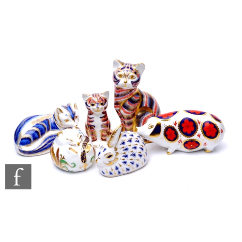 98 - A collection of Royal Crown Derby paperweights, including seated cat, red back stamp and gold stoppe... 