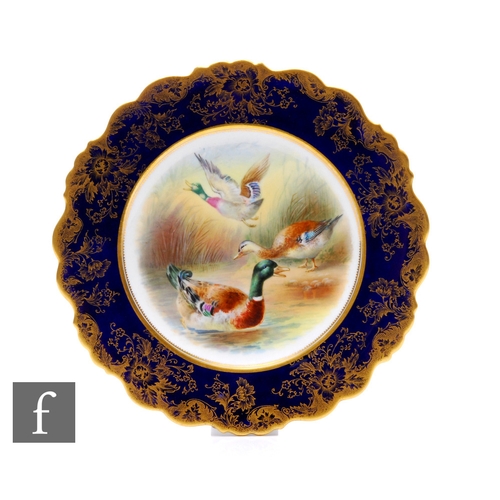 103 - An early 20th Century cabinet plate, in the style of Coalport, painted with mallards on water and in... 