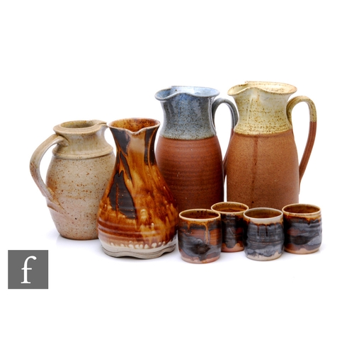 106 - A studio pottery saltglazed stoneware jug by Jason Braham, with grooved strap handle and flattened r... 