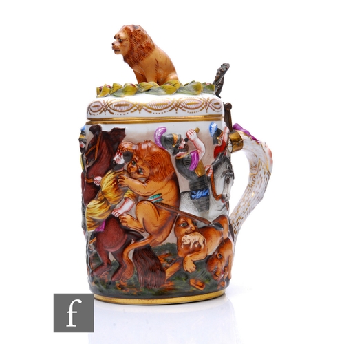 112 - A late 19th Century Capodimonte porcelain lidded stein, relief moulded in the round with lion huntin... 