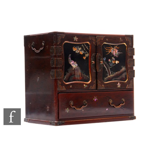 529 - An early 20th Century Japanese lacquered desk top cabinet decorated with mother of pearl highlights,... 