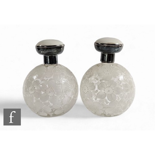 169 - A pair of early 20th Century enamelled scent flasks and stoppers, decorated with flower heads over c... 