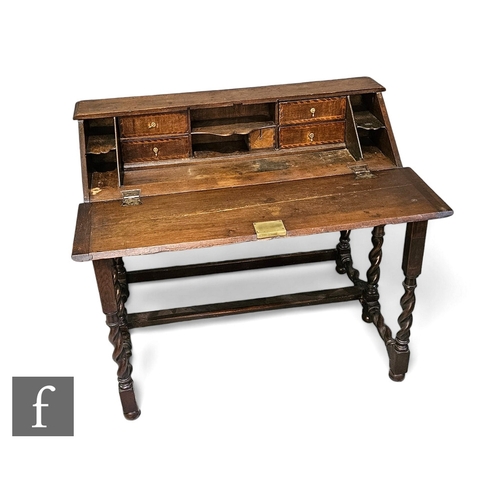 729 - An early 19th Century oak gated front desk, the sloping top opening to reveal pigeon hole and drawer... 