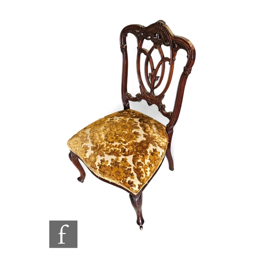 732 - A Victorian walnut scroll back easy chair, scroll open arms on turned fluted legs to the front, with... 