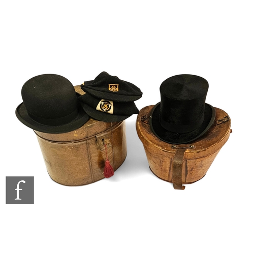 546 - A black felt top hat by Sam Evans, Llanelly [sic], in leather hat box, a bowler hat 'The Perfectus',... 