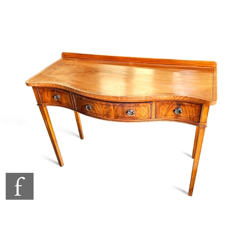 735 - A George III style line inlaid mahogany serpentine front three drawer dressing table on square taper... 