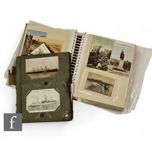 571 - An Edwardian postcard album with real photographic cards to include a full length Titanic card with ... 