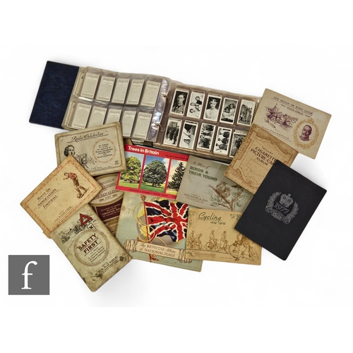 585 - A collection of cigarette cards contained in a vinyl flip album, to include Players and Wills, and v... 