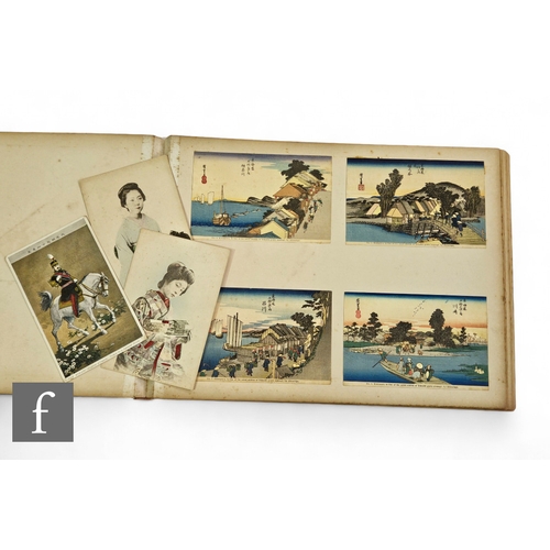 588 - An album of early 20th Century Japanese colour tinted postcards.PLEASE VIEW CONDITION REPORT... 