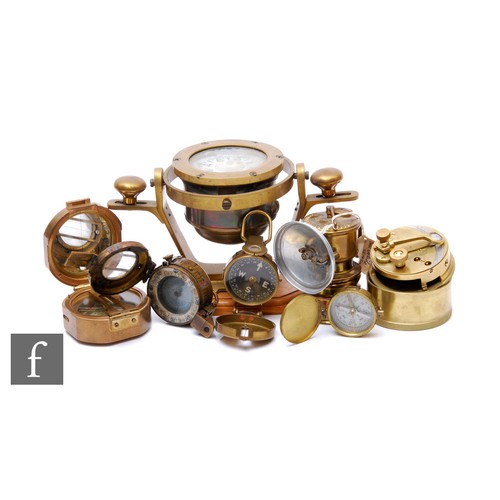 561 - A replica brass nautical compass on binnacle stand and five other similar compasses including a hand... 