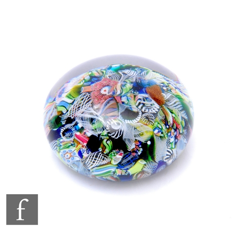 452 - A Clichy or Baccarat glass paperweight of domed form, internally decorated with a scramble ground, i... 