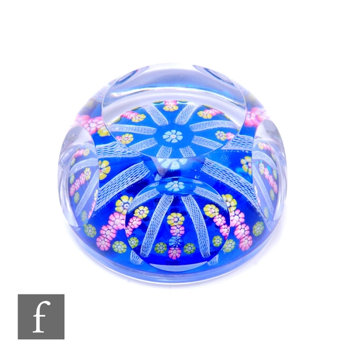 463 - A later 20th Century Whitefriars glass paperweight, internally decorated with a central blue flower ... 